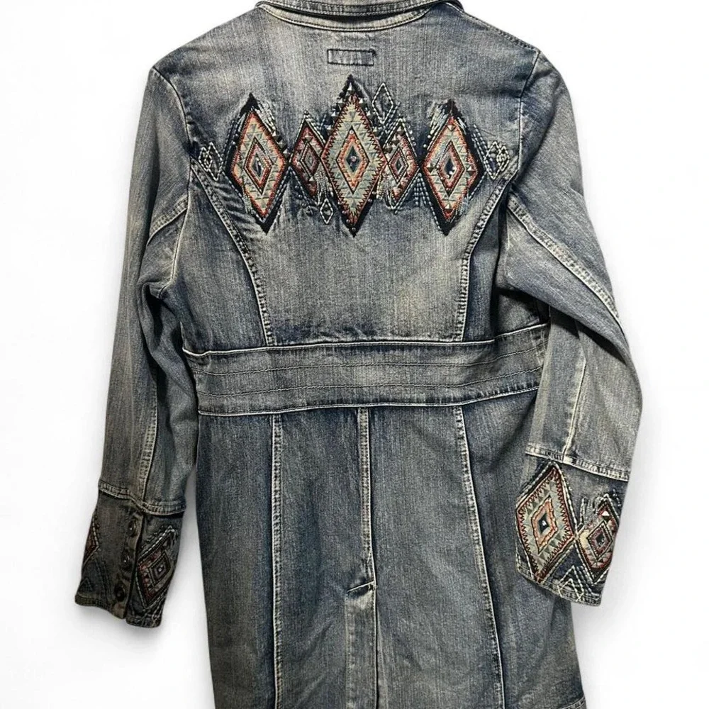 Blue denim jacket with embroidered sleeves,‎ featuring a boho western vibe